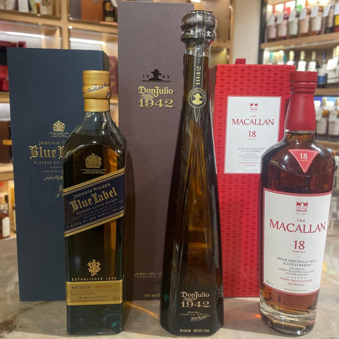 Three bottles of Johnnie Walker Blue Label, Don Julio 1942, and The Macallan 18 
